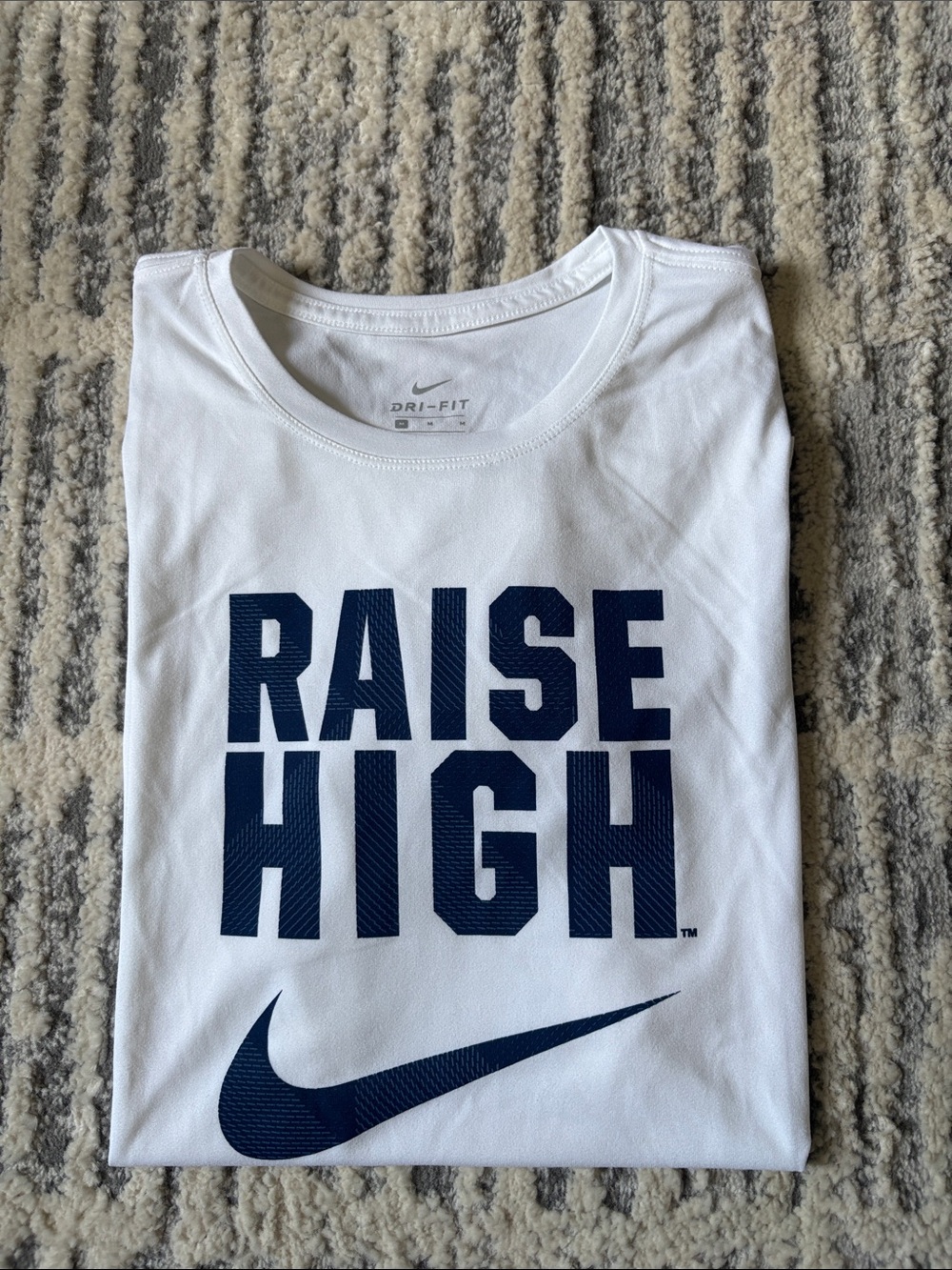 Nike Women’s White Dri Fit Tee with Navy 'Raise High' Graphic